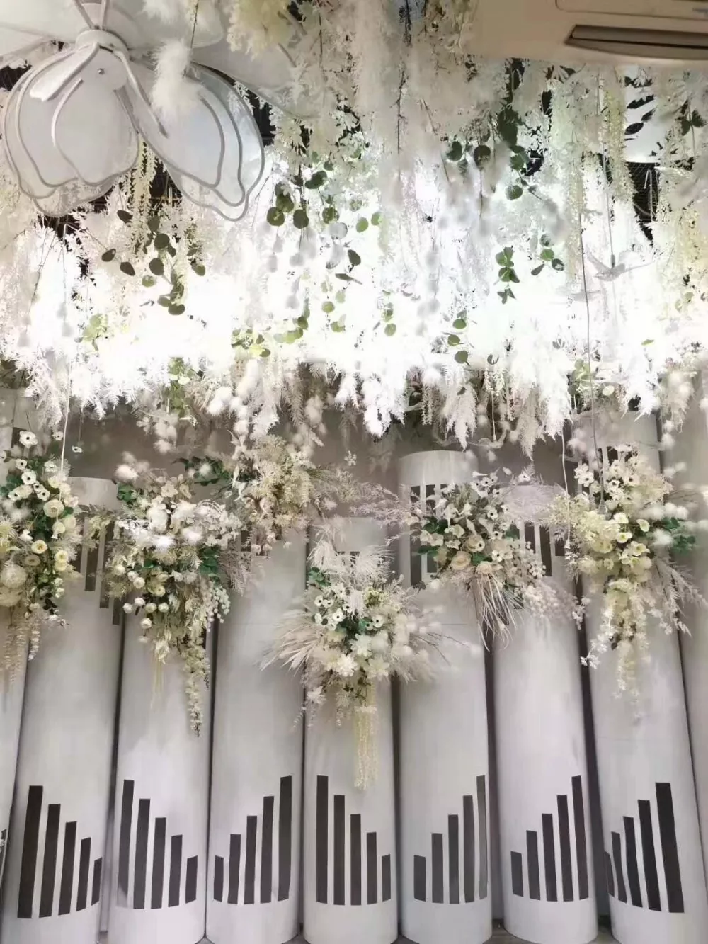 Minimalist wedding style with white faux tulip centerpieces and chair decor